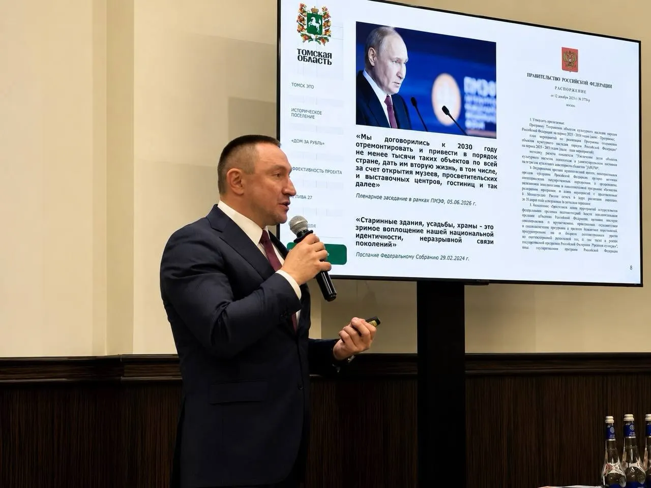 На форуме в Москве замгубернатор представил муниципальную программу как успешную, не упомянув, что региональные власти больше не выделяют средства на реставрацию деревянного наследия Томска и что восстановлено значительно меньше домов, чем заявлено.