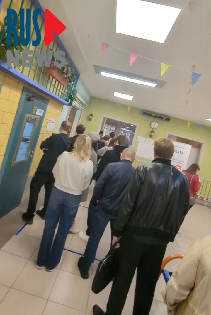 Очередь за бумажным бюллетенем на участке, размещённом в здании школы в Митино, растянулась по коридору. Желающие проголосовать выстраиваются в длинную очередь.